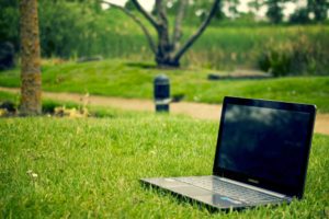 Hiring Remote Workers (laptop in a grassy park)