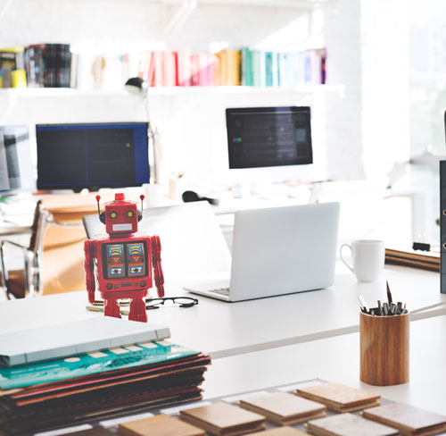 Manual vs. Automated Testing (robot figure on QA tester's desk)